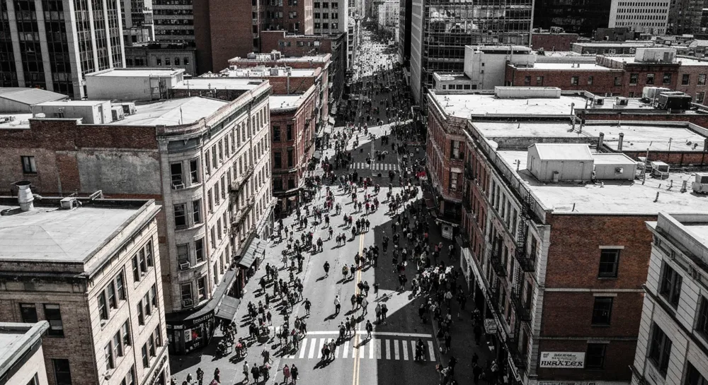 A smoke-filled hallway with emergency exit signs illuminating the path.