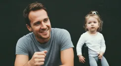 A busy tech workspace with tools and screens displaying code.